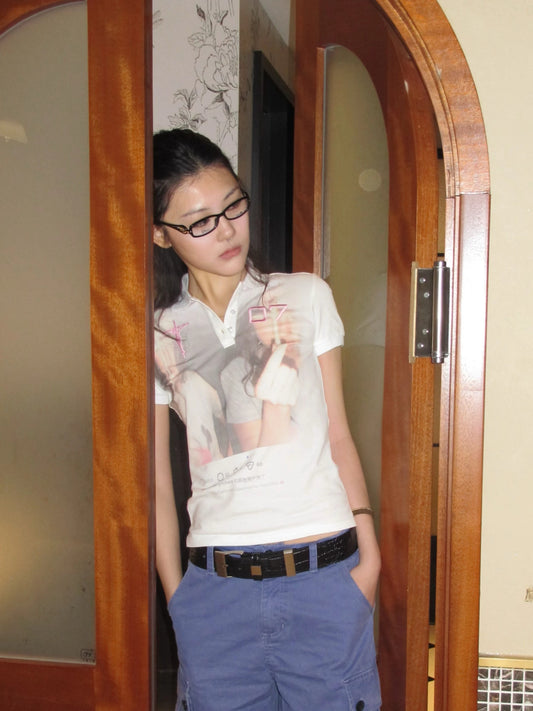 White graphic polo shirt on model in casual outfit