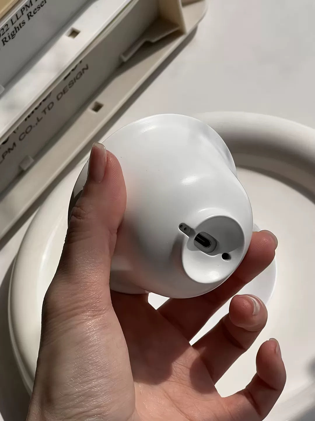 White teacup AirPods case — original product photo 10; earbuds not included