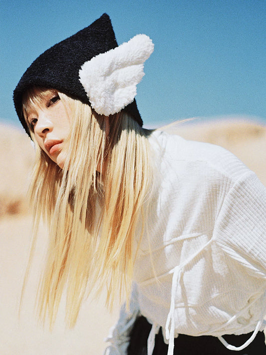 CFIERCE Winged Pointed Knit Beanie - black winged pointed beanie on model, close front view
