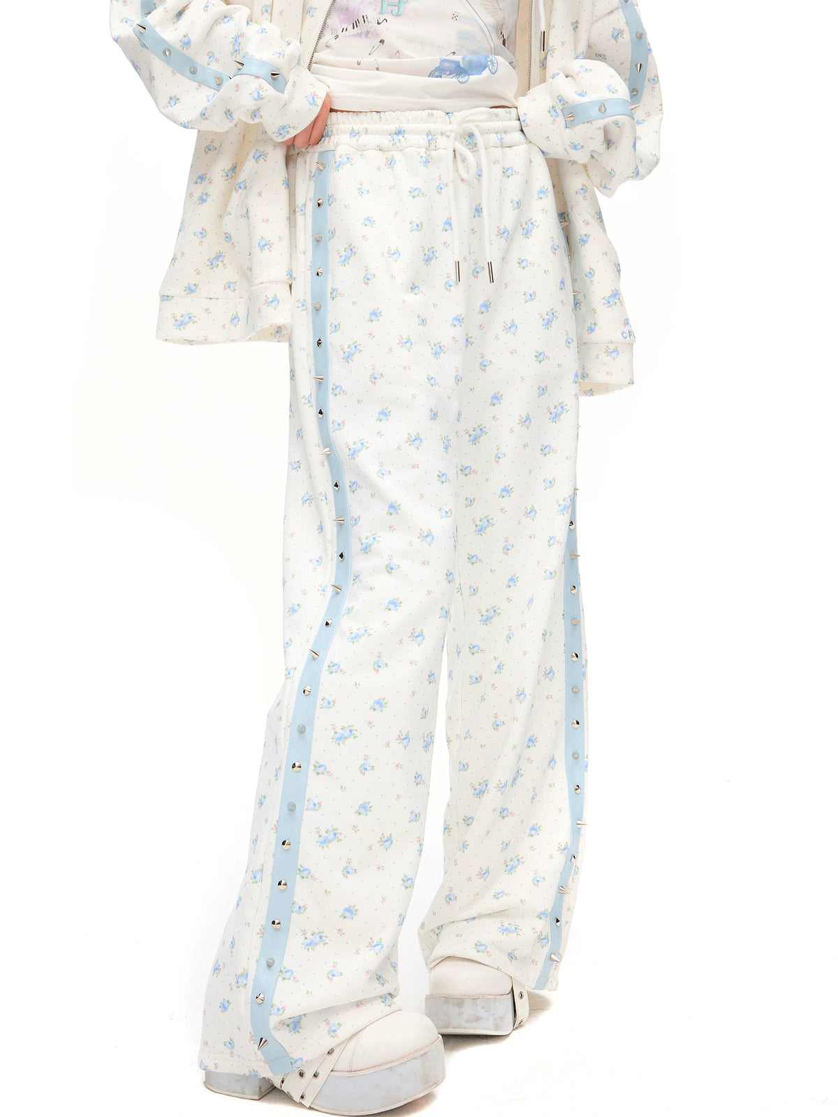 CFIERCE Blue Rose Studded-Stripe Sweatpants - blue floral print and side studs on model