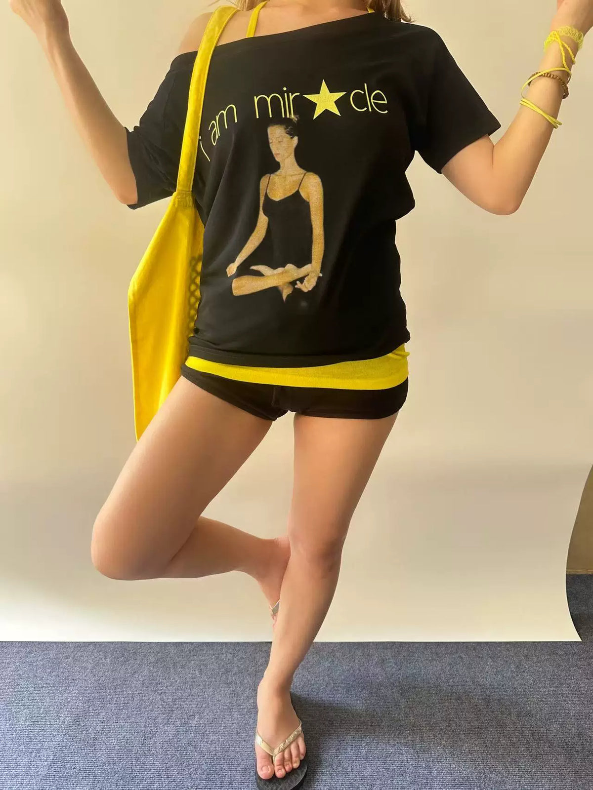 RebelAngel Miracle black graphic tee with yellow bag styling