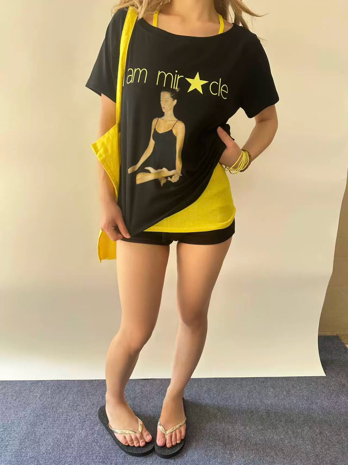 RebelAngel Miracle black graphic tee styled with yellow top
