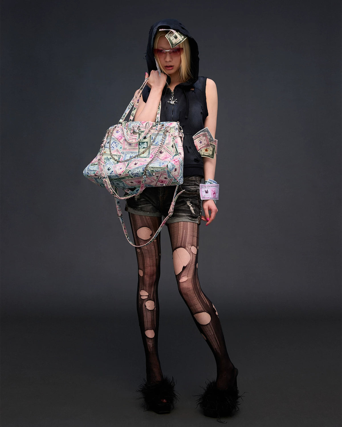 CFIERCE Money Print Multi-Strap Tote Bag - currency-print bag held in front of black outfit