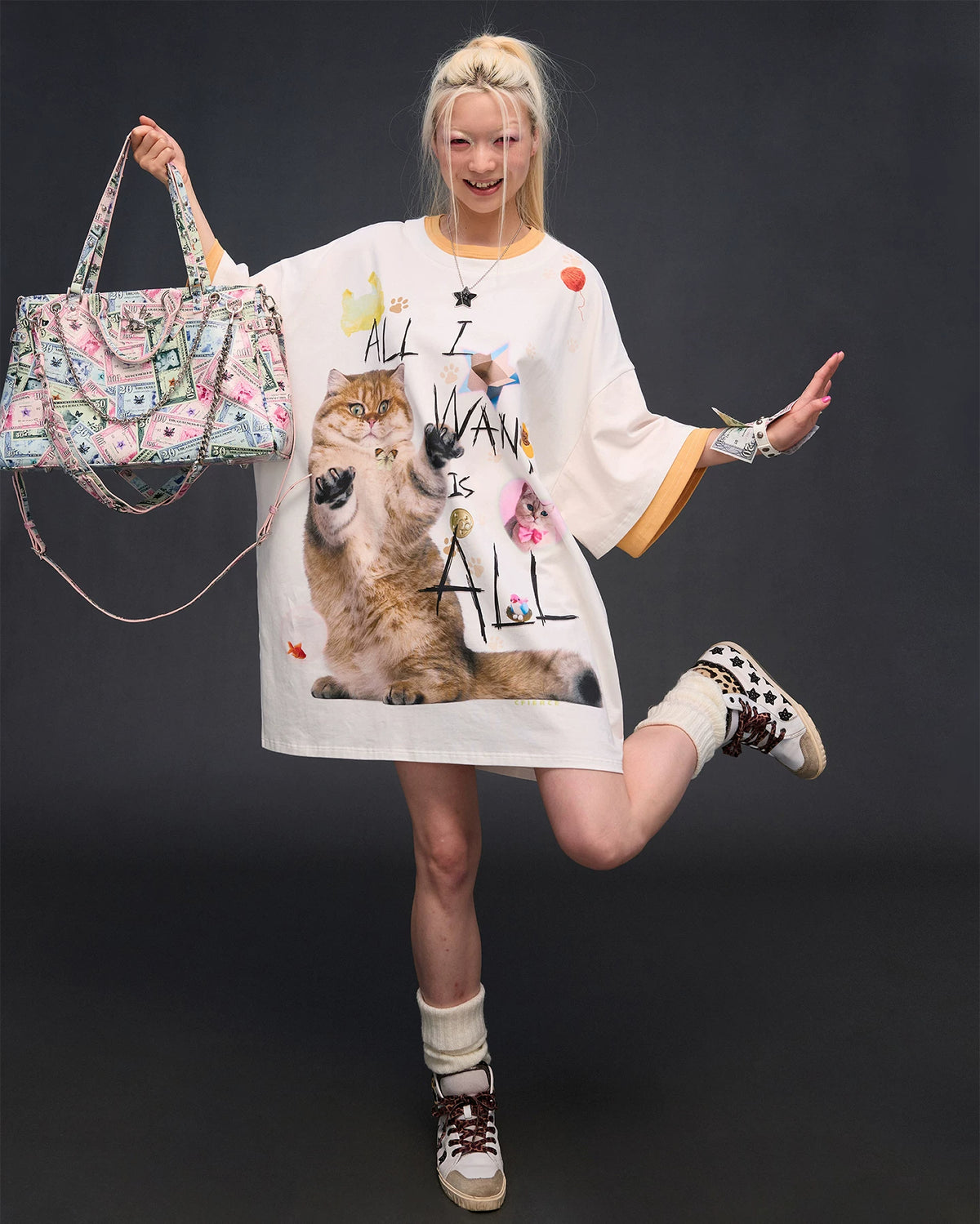 CFIERCE Money Print Multi-Strap Tote Bag - currency-print bag lifted by handle in full outfit