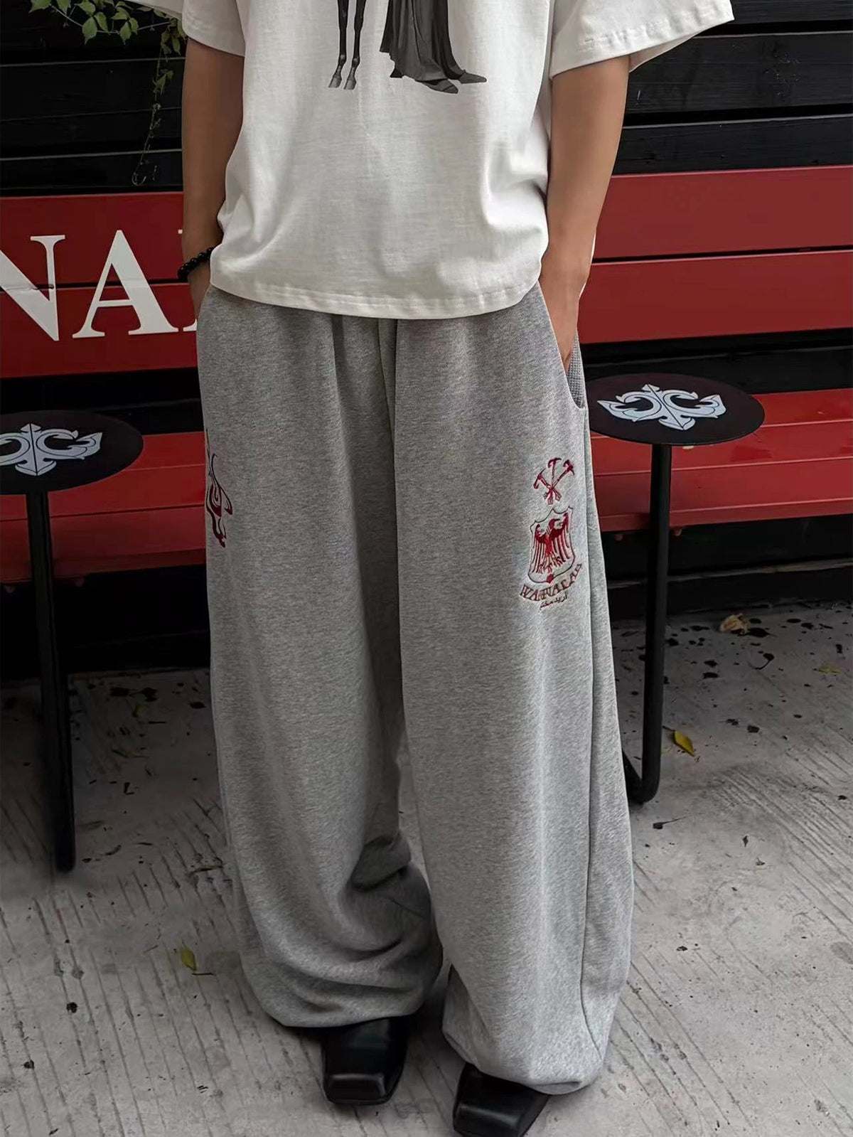 WANNA LAB Greyhound Flame Embroidered Cuffed Wide Sweatpants - Gray front on model
