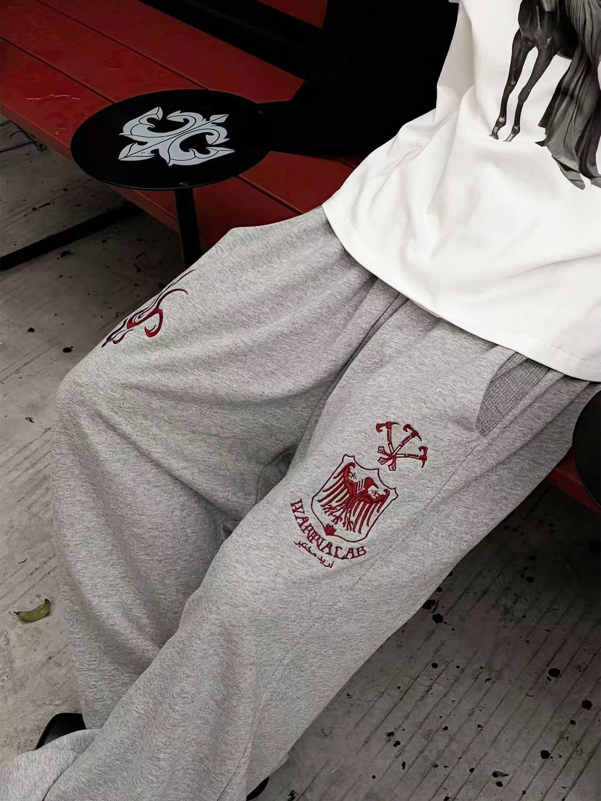 WANNA LAB Greyhound Flame Embroidered Cuffed Wide Sweatpants - Gray side detail on model