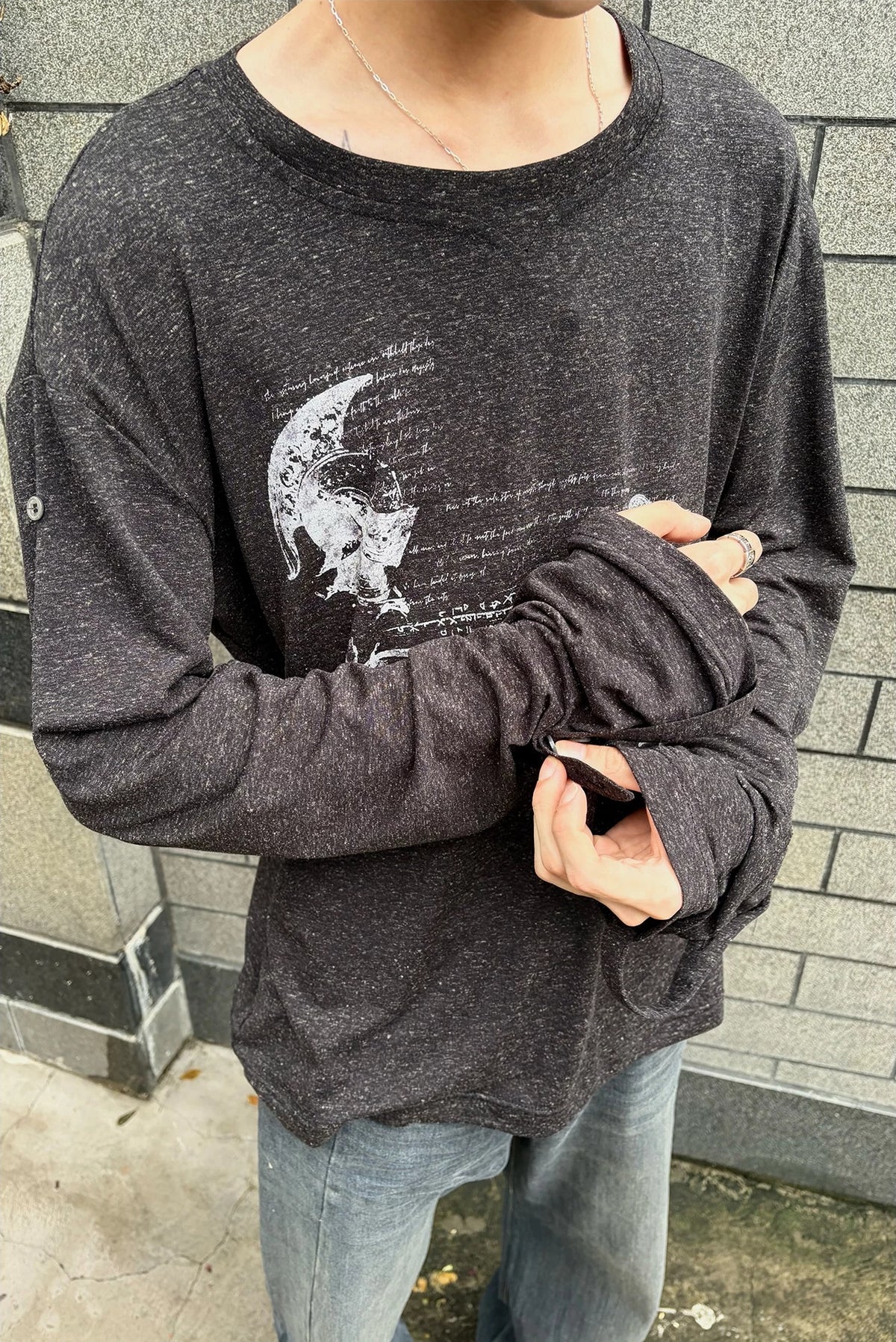 WANNA LAB Odyssey Knight Sword Print Linen Blend Roll-Up Sleeve Tee - Black front on model, arms crossed