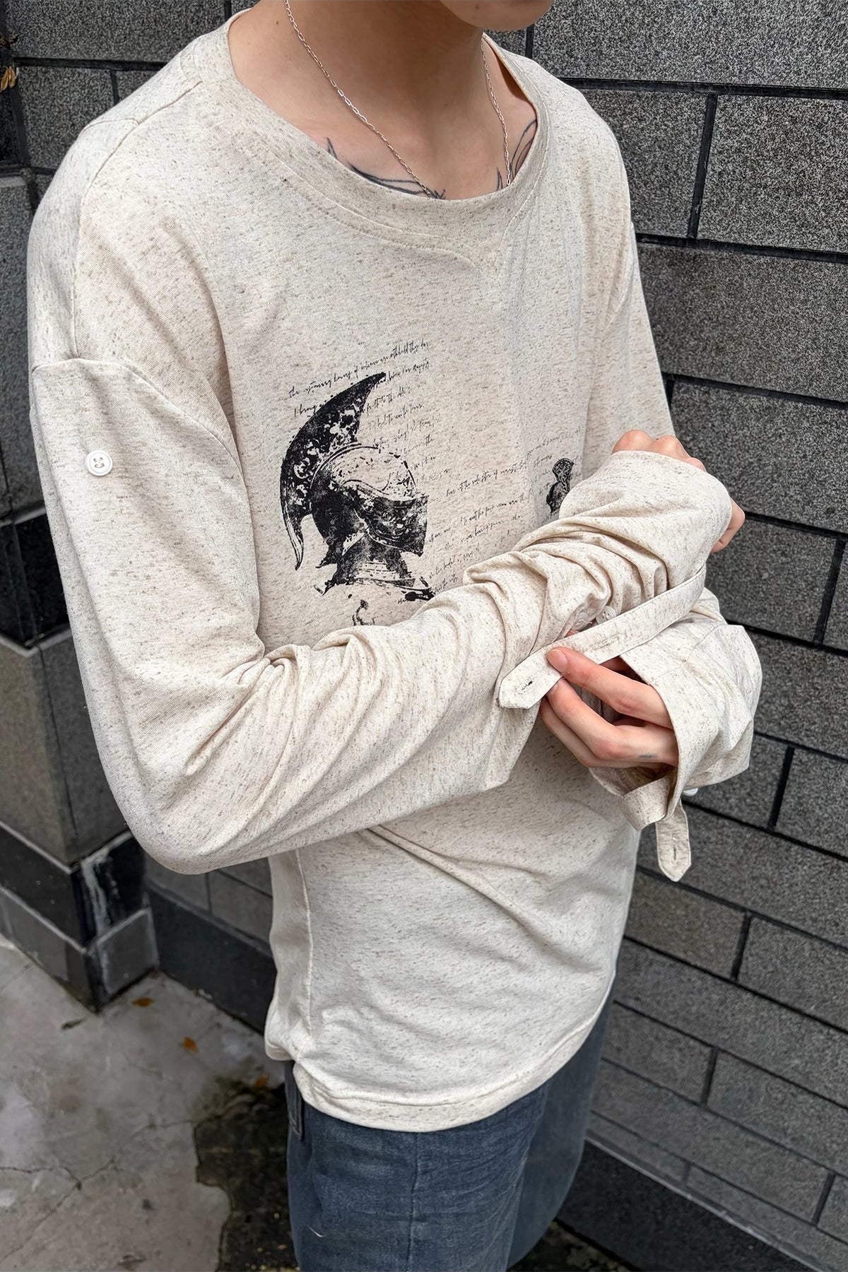 WANNA LAB Odyssey Knight Sword Print Linen Blend Roll-Up Sleeve Tee - Apricot side on model, roll-up sleeve tab detail