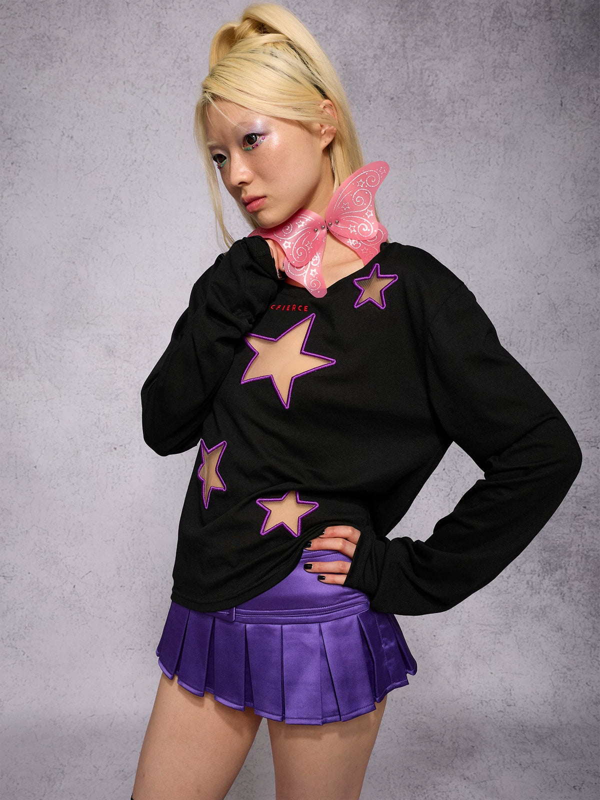 CFIERCE Satin Pleated Mini Skort - purple pleated skort worn with black star sweater