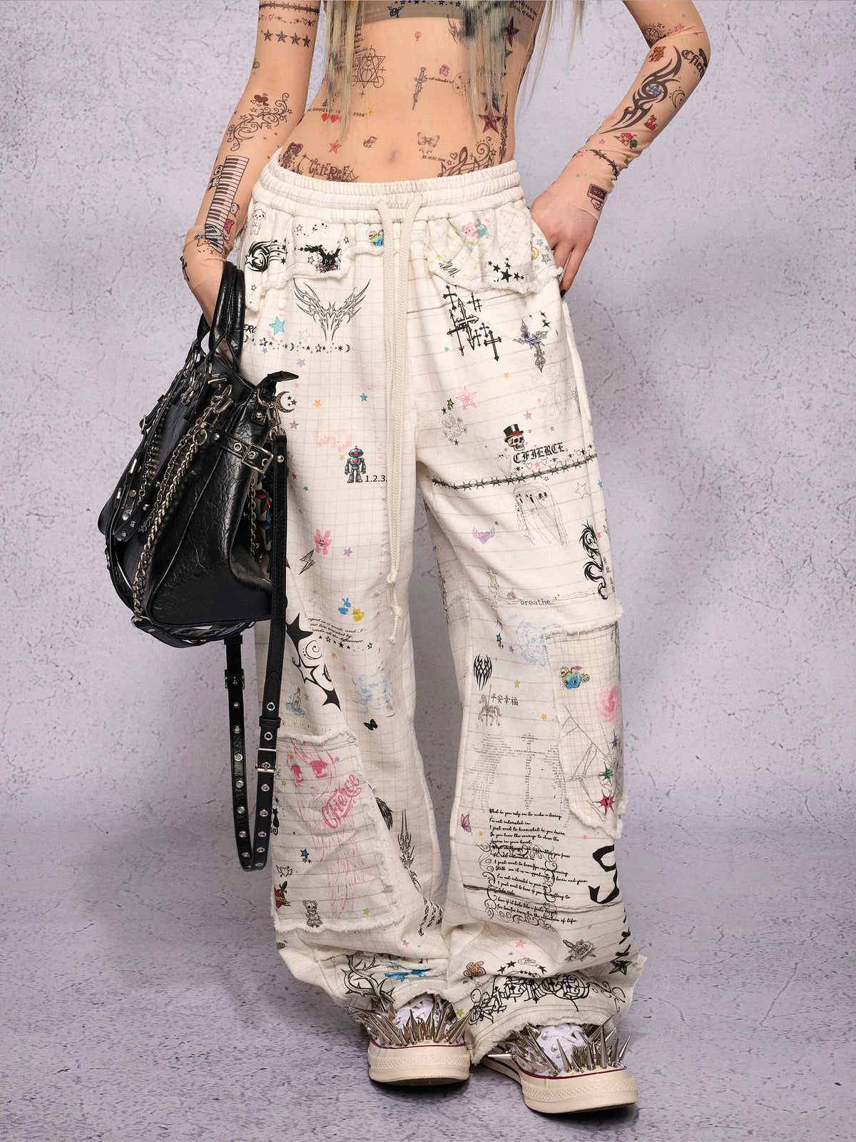 CFIERCE Distressed Manuscript Graphic Sweatpants - white graphic sweatpants front on model