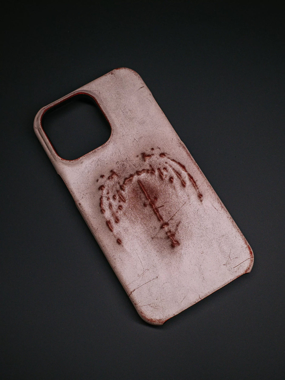 Rubbed red bat wing iPhone case on dark background