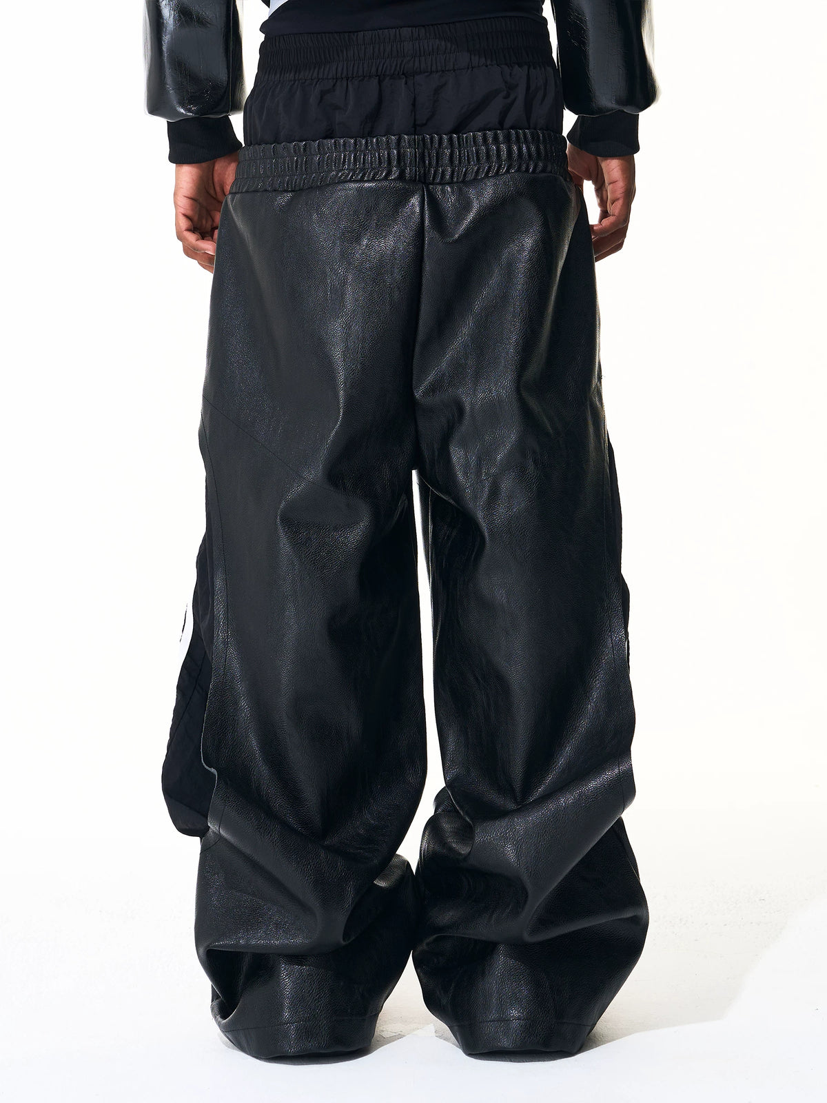 Rear view of black leather-look wide-leg pants