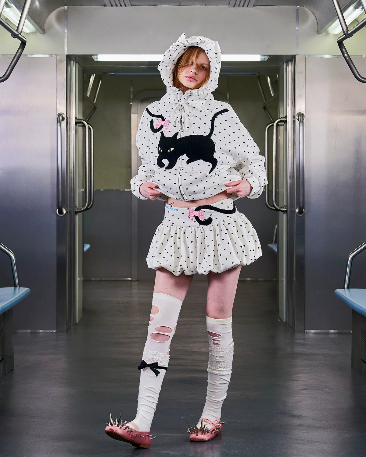 CFIERCE Cat-Tail Heart Dot Bubble Mini Skirt - white heart-dot bubble mini skirt worn on model in subway