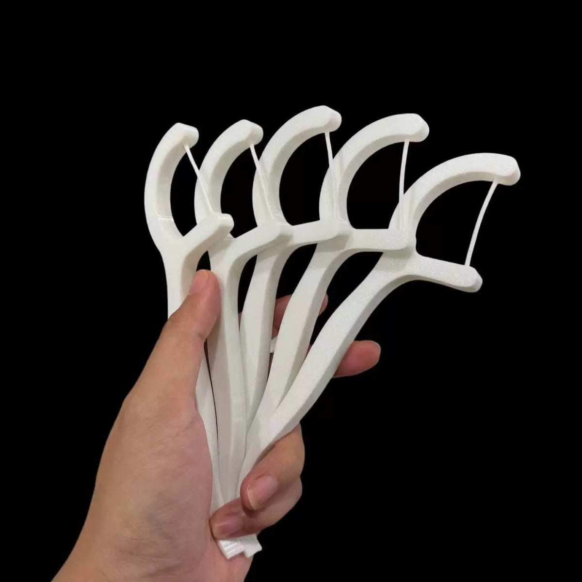 White dental-floss-pick-shaped decor without light