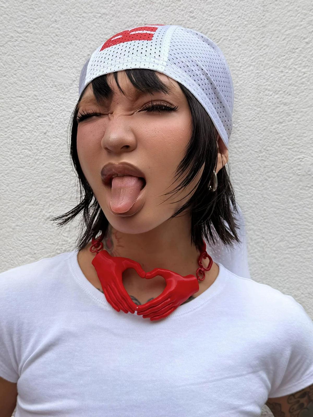 Red heart hands necklace styled with white shirt